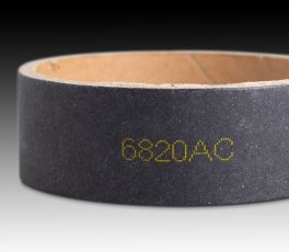CIJ product marking: single line alpha-numeric code in yellow ink on a black corrugate core