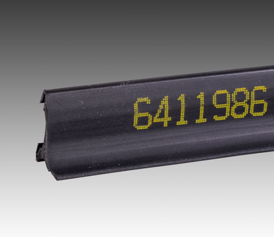 CIJ product marking: single line alpha-numeric code in yellow ink on black rubber part