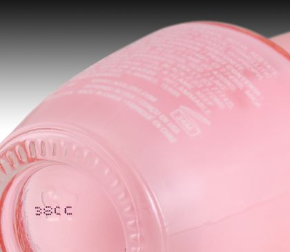 CIJ product marking: one line alpha-numeric code in black ink on glass cosmetic packaging