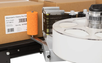Videojet 9560 labeling brown corrugate cases on a packaging line