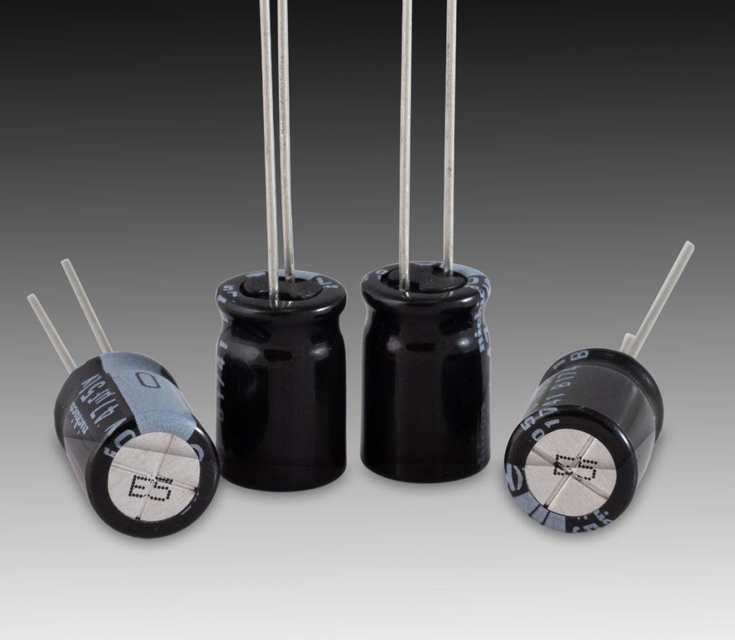 CIJ product marking: one-line alpha-numeric code in black ink on metal capacitor ends