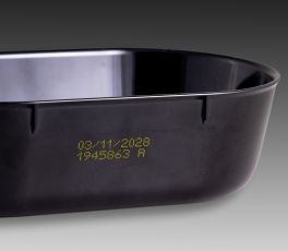 CIJ product marking: two line alpha-numeric code in yellow ink on a black plastic tray
