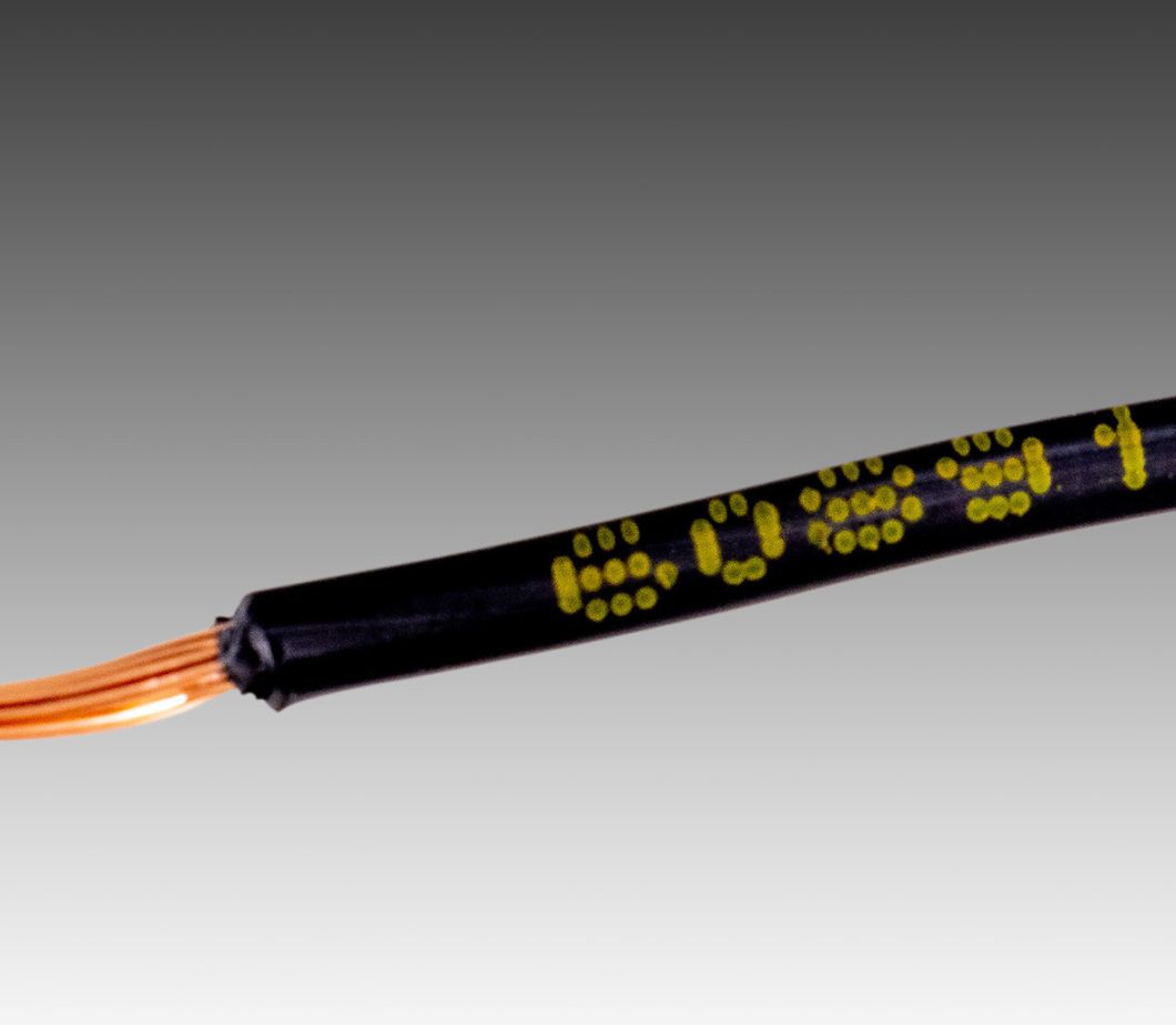 CIJ product marking: single line alpha-numeric code in yellow ink on black plastic cable jacket